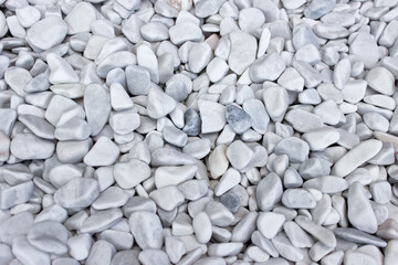 Many white polished pebbles randomly arranged.