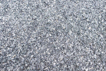 Background with many small gray stone used as decorative material in landscape design.