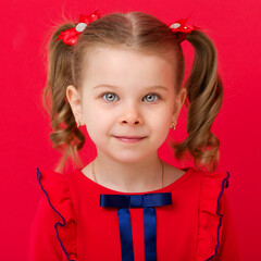 Cute blue eyed girl staring at camera in studio