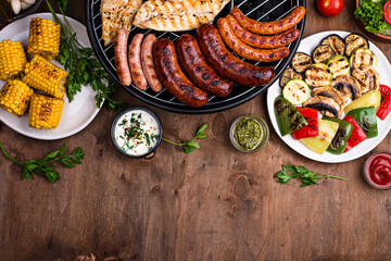 Grilled sausages, meat, and vegetables.