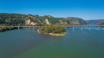 Rio Maule, constitucion, chile, horizontal aerial view with drone of the river and city bridge