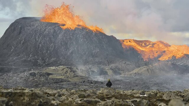 Man Watching Lava Erupting From Fagradalsfjall Volcano In Iceland