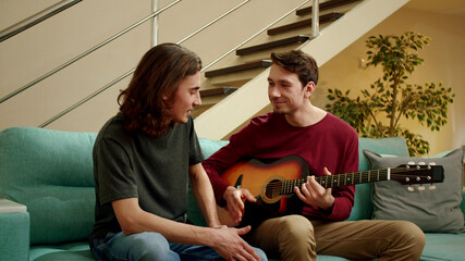 Friends are playing guitar and singing songs 