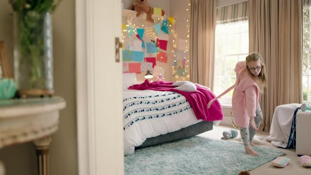 happy little girl dancing in bedroom practicing ballet dance moves having fun playing pretend wearing pajamas enjoying weekend at home