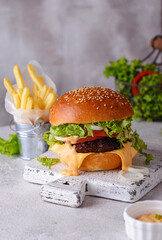 Cheeseburger with beef cutlet and vegetables