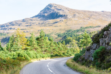 Mountainous landscape along A832 road running through the Torridon region in Scotland.