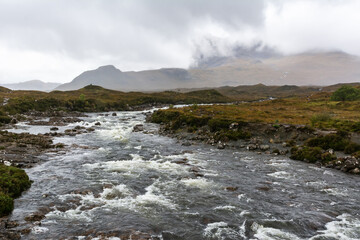 River Sligachan in the Isle of Skye in Scotland. View on a foggy day, with Cuillin mountain range in the background.