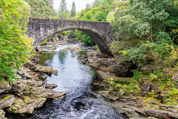 The Old Invermoriston Bridge, also known as the Thomas Telford bridge, spanning river Moriston (Glenmoriston) in the Highlands of Scotland.