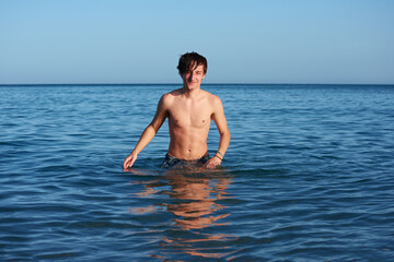 A portrait of a young fit caucasian male in the sea