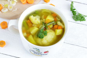 Homemade vegetable soup with cauliflower, potatoes, and beans. Healthy, dietary meals