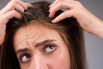 Naklejka premium Stressed woman is very upset because of hair loss. Haircut and straightening hair care. Serious hair loss problem for health care shampoo.