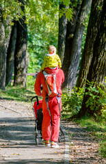 Father with her son walking in the summer Park
