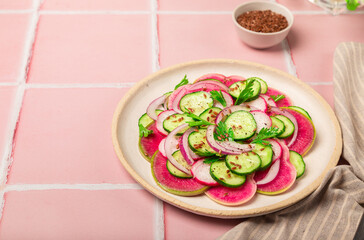 Salad with watermelon radish, cucumber and red onion