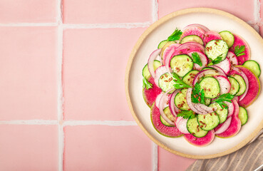 Salad with watermelon radish, cucumber and red onion