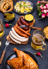 Oktoberfest dishes with beer, pretzel and sausage