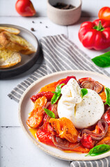 Burrata cheese with baked tomatoes, pepper, red onion and fresh basil