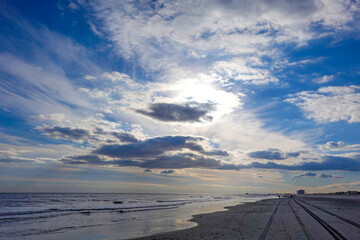 Beautiful cloudscape over the ocean and a deserted beach