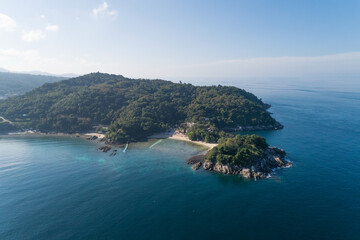 High angle view Tropical sea with wave crashing on seashore and high mountain located in Phuket Thailand aerial view drone top down Amazing nature view landscape Beautiful sea surface.