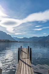 Small wooden dock entering Lake Geneva in cloudy day