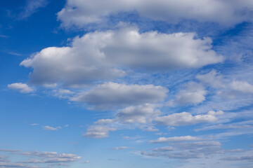 Deep blue sky behind a dramatic white puffy cloudscape