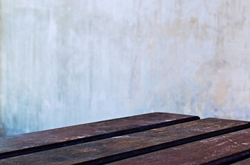 wooden table with gray cement wall background
