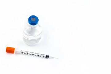 Close-up of the vial and the syringe to place the vaccine on a white background. isolated