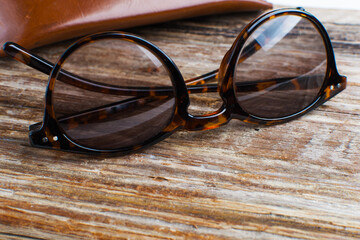 glasses and leather case on a wooden table