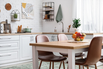Stylish interior of modern kitchen with dining table