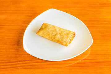 Traditional crispy spring roll stuffed with vegetables and meat cooked in a Chinese restaurant