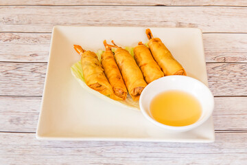 Delicious Asian rolls stuffed with prawns made from crunchy dough fried in olive oil and dip sauce