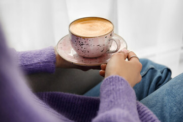 Woman drinking tasty coffee at home, closeup