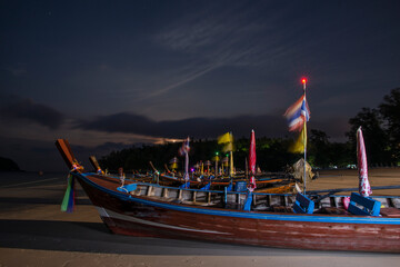 Long-tail boats stranded in the sand on Kata Beach on Phuket Island