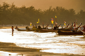 photographing long-tail boats at sunrise on a thai beach