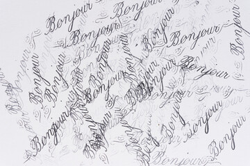 rubber stamp background with the french word bonjour repeated multiple times © eugen