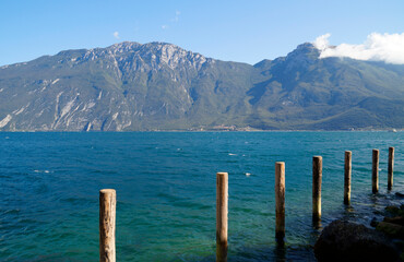 a beautiful old marina in the Italian town of Limone on turquoise lake Garda with mountains in the background (Lombardy)	
