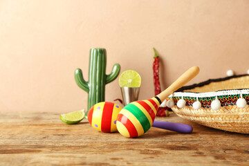 Mexican maracas and sombrero on wooden table