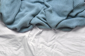 Knitted plaid on bed, closeup