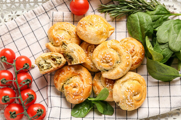 Puff pastry stuffed with spinach and tomatoes on tray