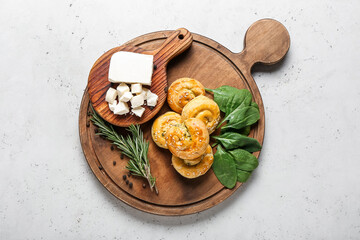 Fototapeta na wymiar Puff pastry stuffed with spinach, feta cheese and herbs on light background