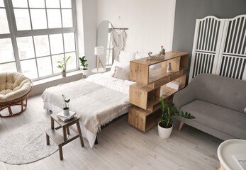 Interior of stylish room with comfortable bed