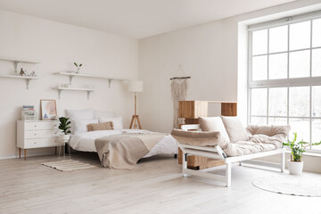 Fototapeta na wymiar Interior of stylish room with comfortable bed