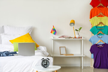 Interior of stylish bedroom with flag of LGBT