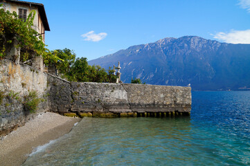 a beautiful old abandoned marina in the Italian town of Limone on turquoise lake Garda with...