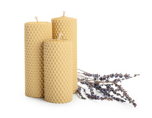 Wax candles and lavender flowers on white background