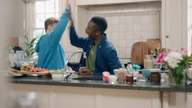 multi ethnic father and son dancing in kitchen teenage boy with down syndrome having fun dance with dad celebrating happy family at home