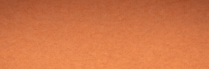 background and texture of orange handmade Indian rag paper created from recycled cotton fabric, panoramic banner