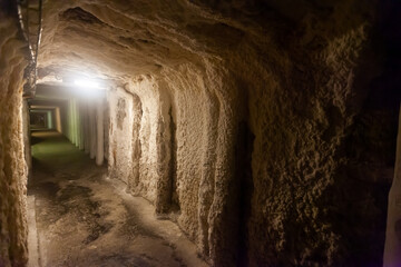 Fototapeta na wymiar Empty illuminated long tunnels in old mines