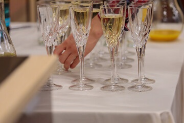 Glasses with champagne and white wine on the table. Corporate, festive event.