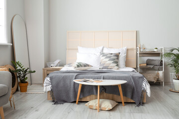 Modern interior of light bedroom with mirror