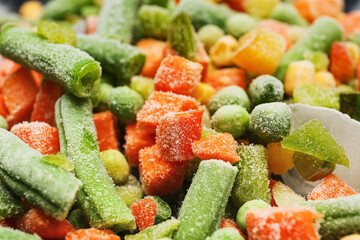 Mix of frozen vegetables as background, closeup